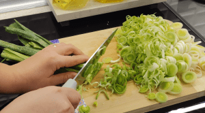 Finely chopped fresh leeks and grated carrots for a savory vegetable pie.