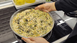Close-up shot of a moist and soft crustless leek and cheese borek slice.