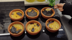 Traditional Turkish creamy milk dessert served in individual clay pots.