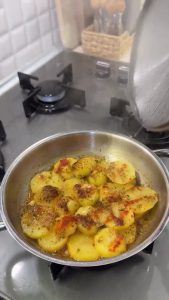 Sprinkling red paprika, dried thyme, and black pepper over the buttery steaming potatoes.