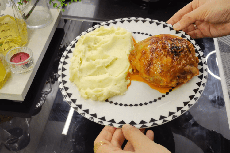 A beautifully roasted Piliç Topkapı chicken bundle served on a bed of creamy mashed potatoes with a rich tomato sauce glaze.