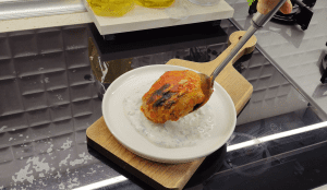 Freshly baked cabbage bundles with cooked rice and a rich tomato glaze.