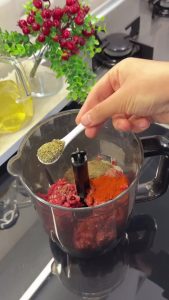 Processing ground beef and onion juice in a food processor to create a smooth döner meat base.
