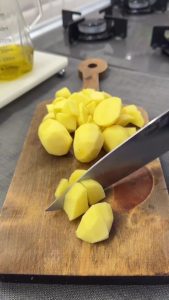 Small cubes of potatoes boiled until tender, drained, and placed in a large mixing bowl.