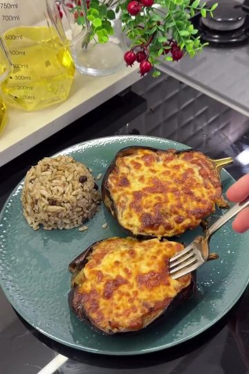A platter of roasted globe eggplant boats topped with garlic tomato sauce and melted kashar cheese.