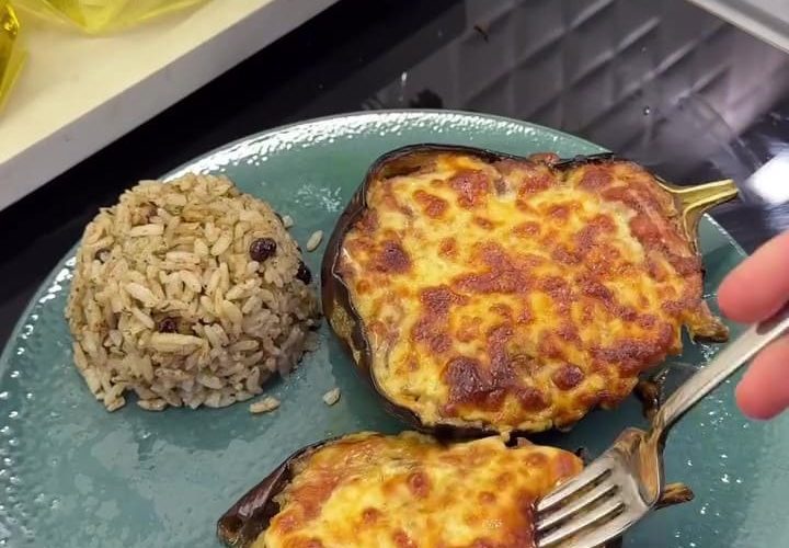 A platter of roasted globe eggplant boats topped with garlic tomato sauce and melted kashar cheese.
