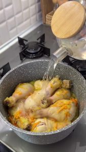 Simmering the chicken stew on medium heat to develop a rich, healthy broth.