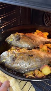 Tucking wet and crumpled parchment paper over the fish tray to lock in moisture while baking.