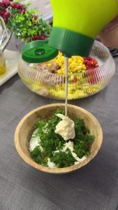 A creamy salad dressing made with yogurt, mayonnaise, minced garlic, curry powder, and fresh dill in a bowl.