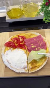 Making a straight cut from the center to the edge of the tortilla using a knife for folding.