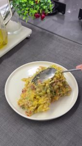 The finished creamy curry potato salad, beautifully garnished and ready to be served.