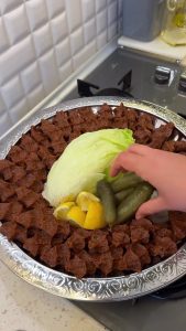 A beautiful final presentation of homemade Turkish çiğ köfte with lettuce and lemon.