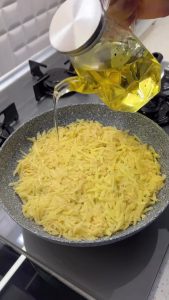 Close-up of a perfectly fried and crispy potato base being checked with a spatula.