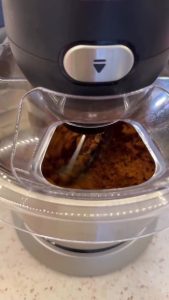 Kneading the vegetarian bulgur mixture in a stand mixer to achieve a smooth consistency.