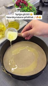 Lining a springform cake pan with parchment paper and brushing the bottom with melted butter.