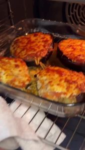 The final result of baked eggplant boats with bubbly, golden melted cheese straight from the oven.