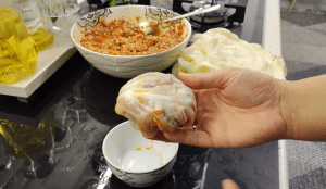 Mixing rice, ground beef, and spices in a glass bowl for the filling.