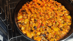 The finished oven-baked chicken and vegetables with a golden-brown roast, ready to serve.