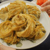 Golden brown Turkish Rose Borek (Gül Böreği) filled with spinach and feta cheese.