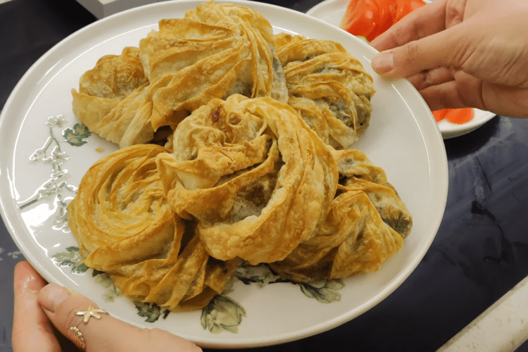 Golden brown Turkish Rose Borek (Gül Böreği) filled with spinach and feta cheese.