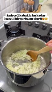Sautéing finely diced onions in a pot with melted butter and vegetable oil for the soup base.