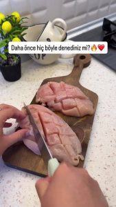 Scoring the surface of a chicken breast in a cross-hatch pattern for better sauce absorption.
