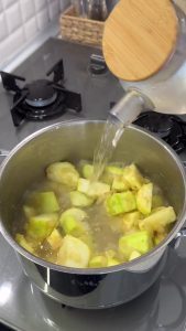 Simmering the diced zucchini in water until they are completely soft and ready to be blended.