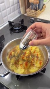 Cooking the potatoes with the lid closed until the butter is completely melted.
