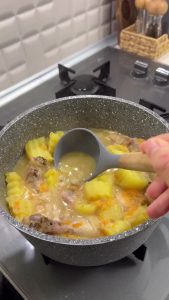 Tempering the lemon dressing with hot broth before adding it back to the chicken stew.