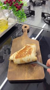 Grilling the folded wrap in a pan until the exterior is perfectly crispy and golden brown.