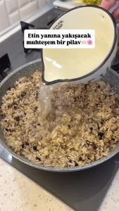 Placing a knob of butter on top of the rice and water mixture before closing the lid.