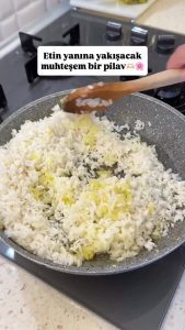 Adding aromatic spices like cinnamon, dried mint, and currants to the rice mixture.
