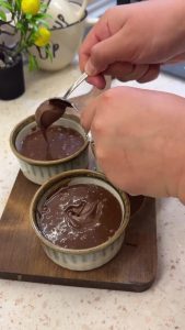 Placing a small spoon of chocolate spread in the center of the unbaked batter.