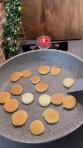 Adding diced green kiwi and sliced bananas to the pancake cereal.