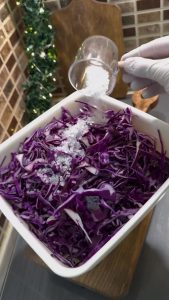 Adding a teaspoon of lemon salt (citric acid) to the cabbage mix.