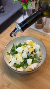 Adding red pepper flakes, paprika, and oregano to the egg and herb mix.