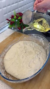 Pouring a small amount of vegetable oil over the dough before the second folding cycle.
