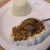 A plate of Alinazik Kebab featuring tender lamb cubes over smoky roasted eggplant and garlic yogurt puree.