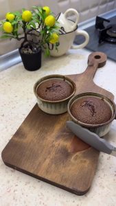 Chocolate soufflé cakes rising in a 200 degree convection oven.