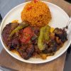 A delicious dish of layered roasted eggplant and spiced ground meat in a glass baking dish.
