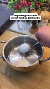 Boiling fresh eggs in a small pot for a healthy Turkish salad.