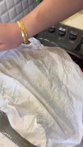 Mixing water with sautéed pepper paste and bringing the sauce to a boil in a small pot.