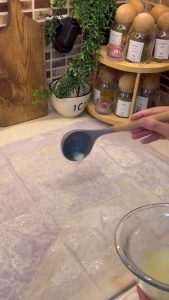 Brushing the milk and oil sauce over a large sheet of Turkish yufka.