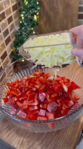 Chopping fresh Turkish sucuk and red capia peppers for the pastry filling.