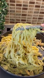 A close-up shot showing the silky texture of the curry pasta sauce.