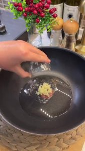 Dusting the shaped bulgur meatballs with flour to prevent them from sticking.
