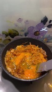 Cooking the eggs until the whites are set and combined with the flavorful onions.