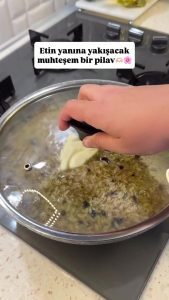 Simmering the aromatic pilaf on the lowest heat setting until all water is absorbed.