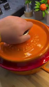 Sealing the baking dish with a sheet of wet, crumpled parchment paper.