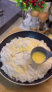 Covering the cheese layer with the remaining shredded yufka pieces.